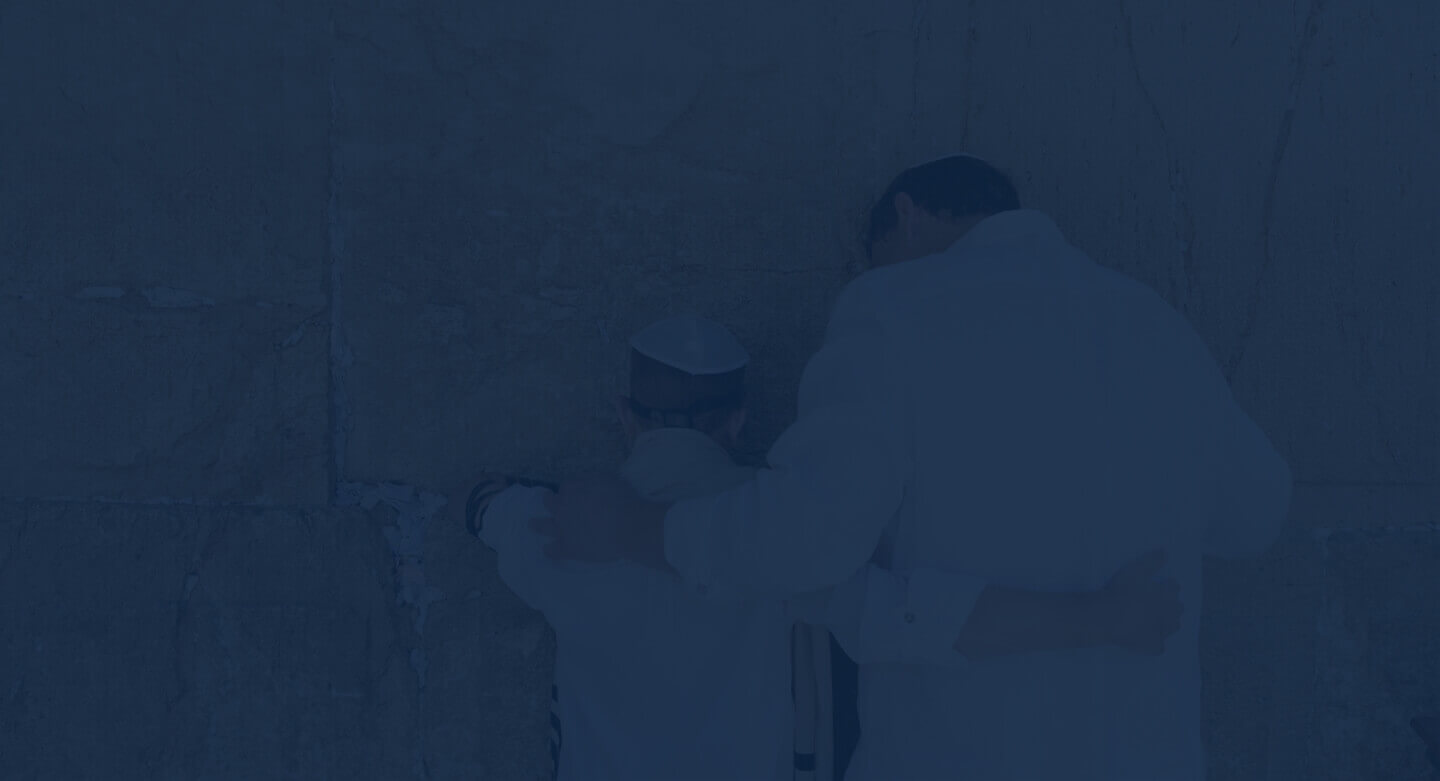 Jewish man and son praying at jerusalem