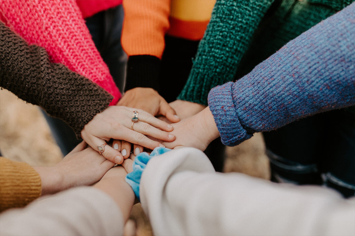Friends with hands piled on top of each other