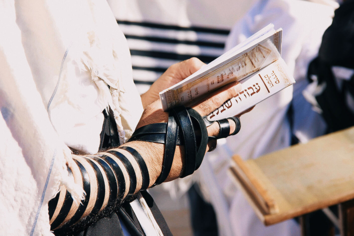 Jewish man praying while wearing Tefillin